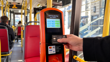 Orange contactless ticket machine inside Prague bus