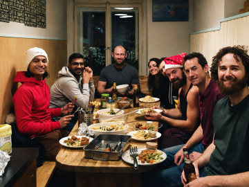 Backpackers sharing a homemade dinner at Hostel ELF Prague